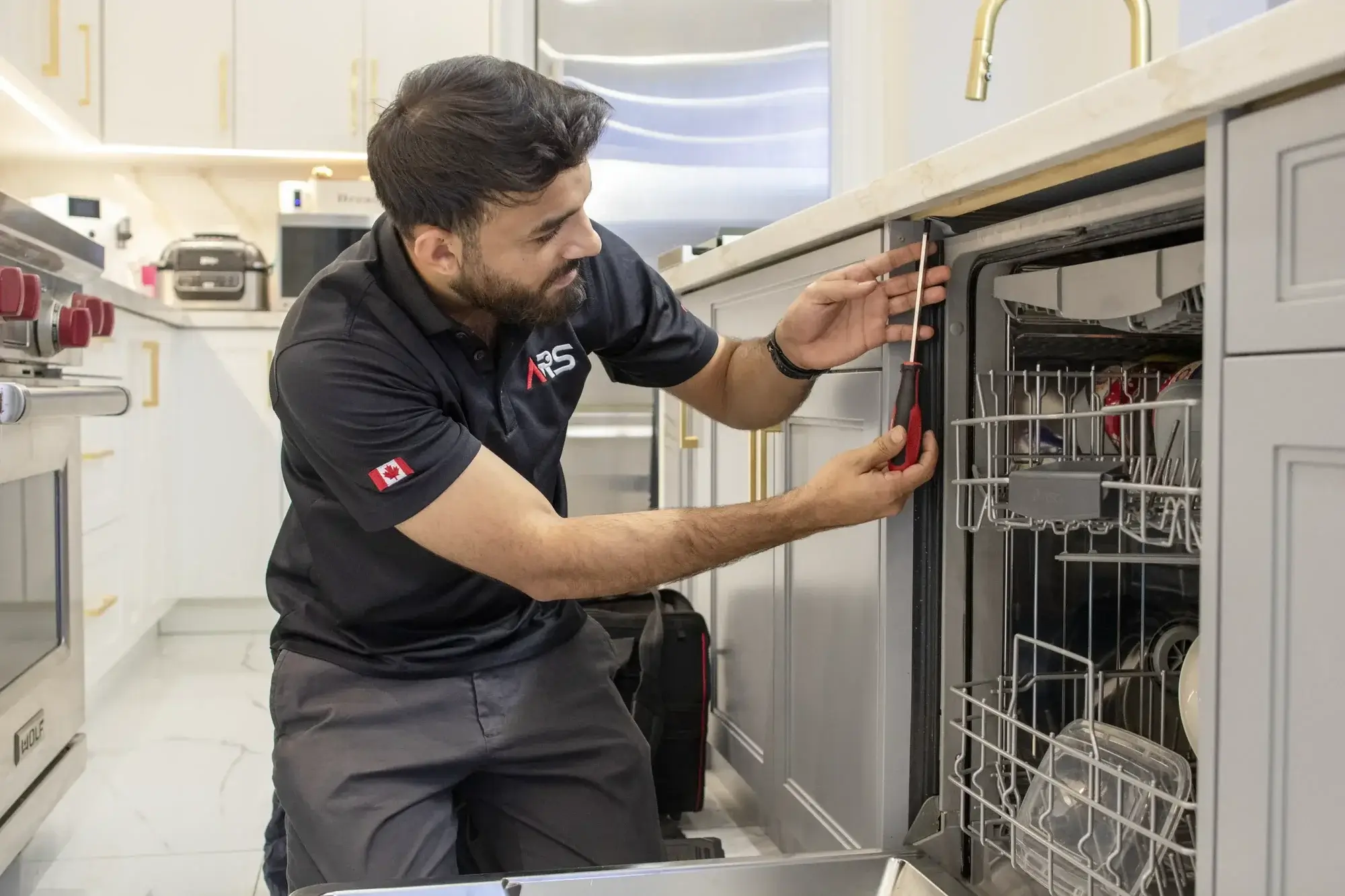 Emergency dishwasher repair technician working in kitchen Emergency dishwasher repair technician working in kitchen