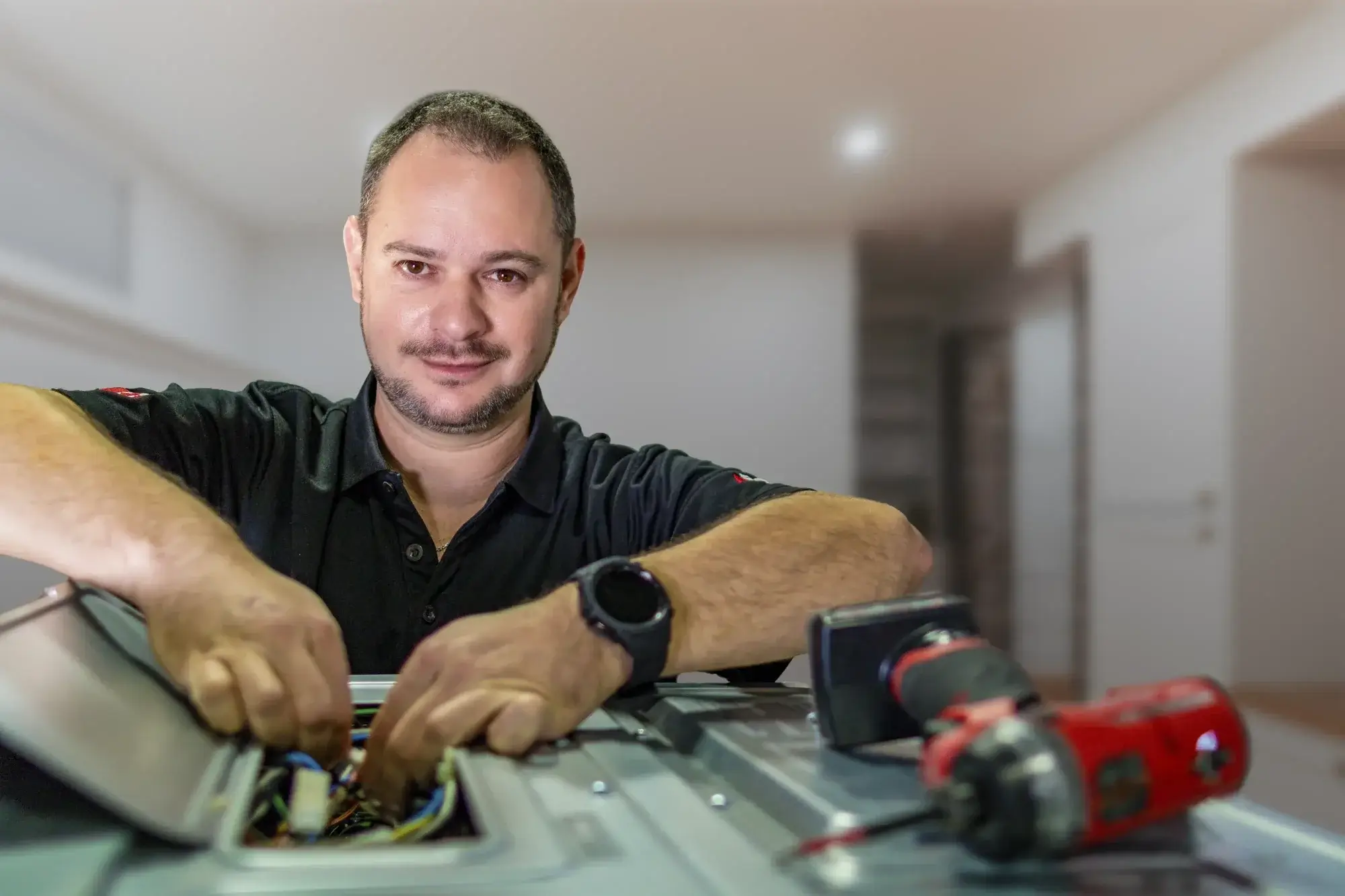 Appliance Repair Technician Working on Electrical Components Appliance Repair Technician Working on Electrical Components